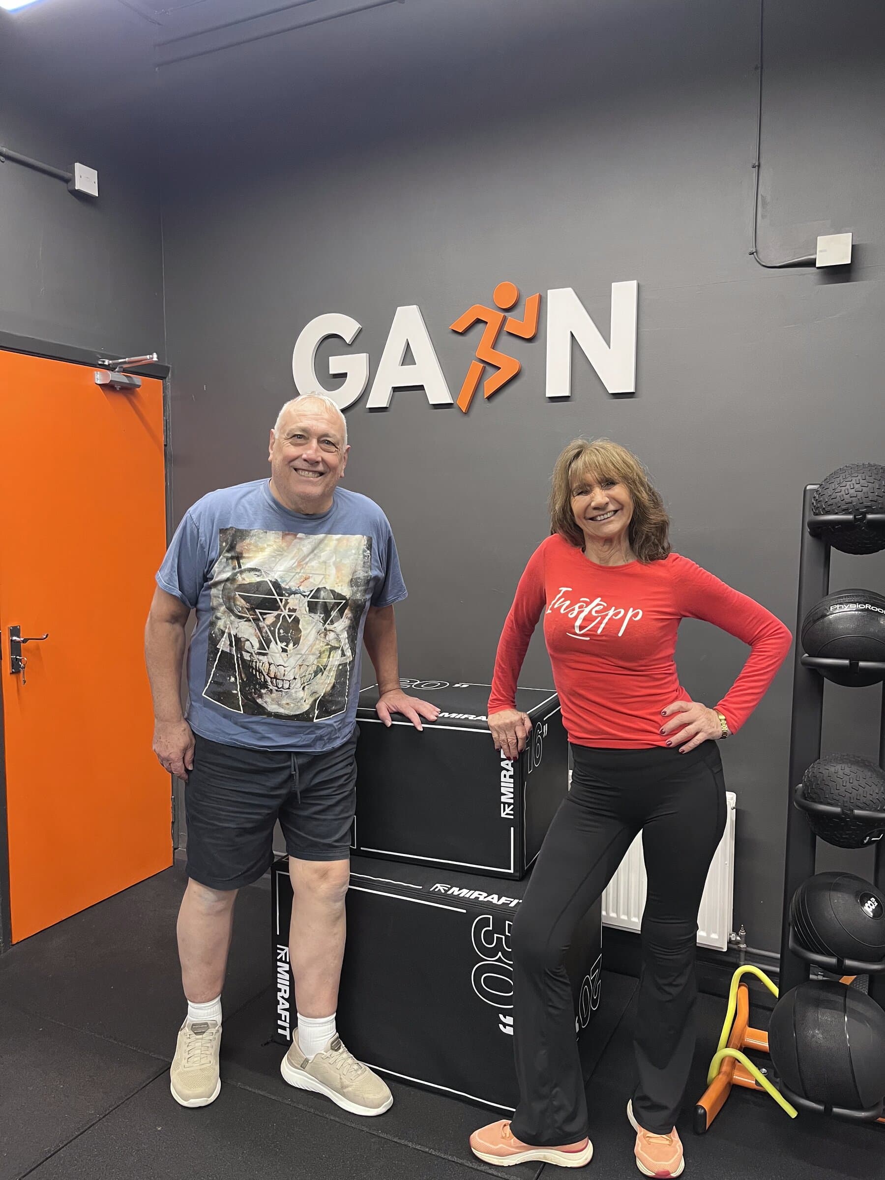 Two members posing at GAIN sign